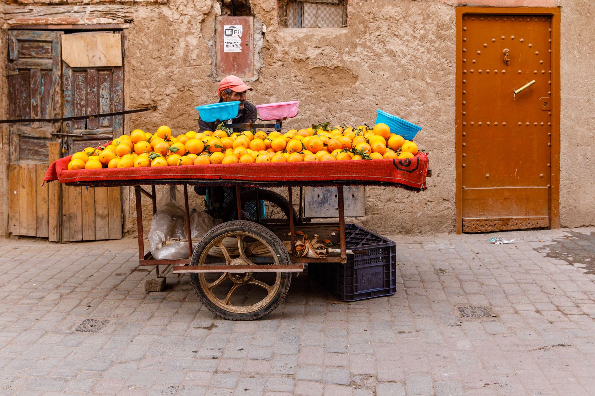 Imlil, Morocco A man selling oranges on a cart in Imlil, Morocco.