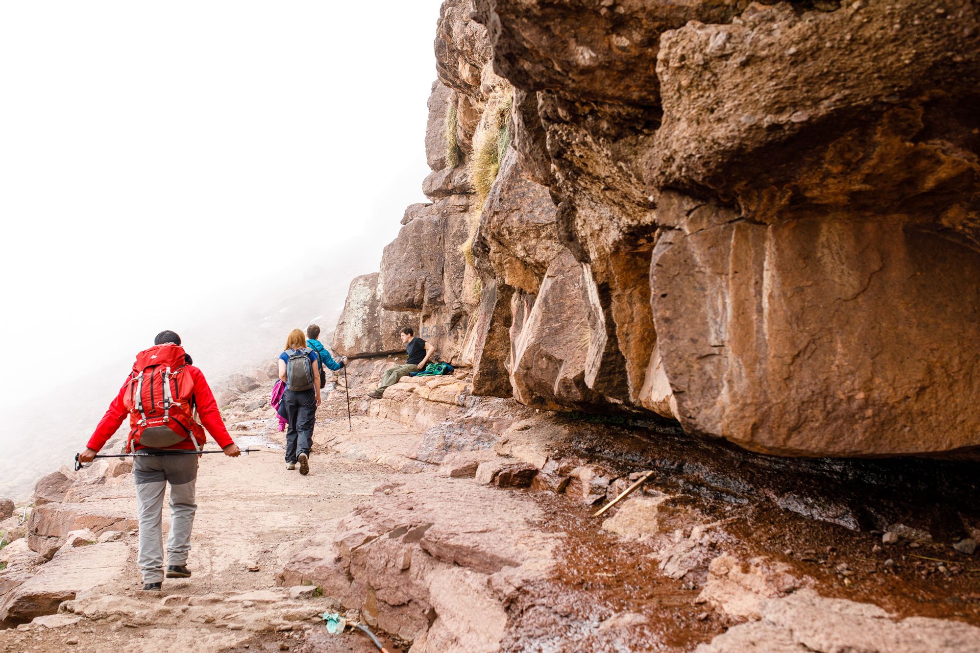 Climbing Mt. Toubkal, Morocco Hikers on a rocky trail leading to the summit of Jebel Toubkal, Morocco