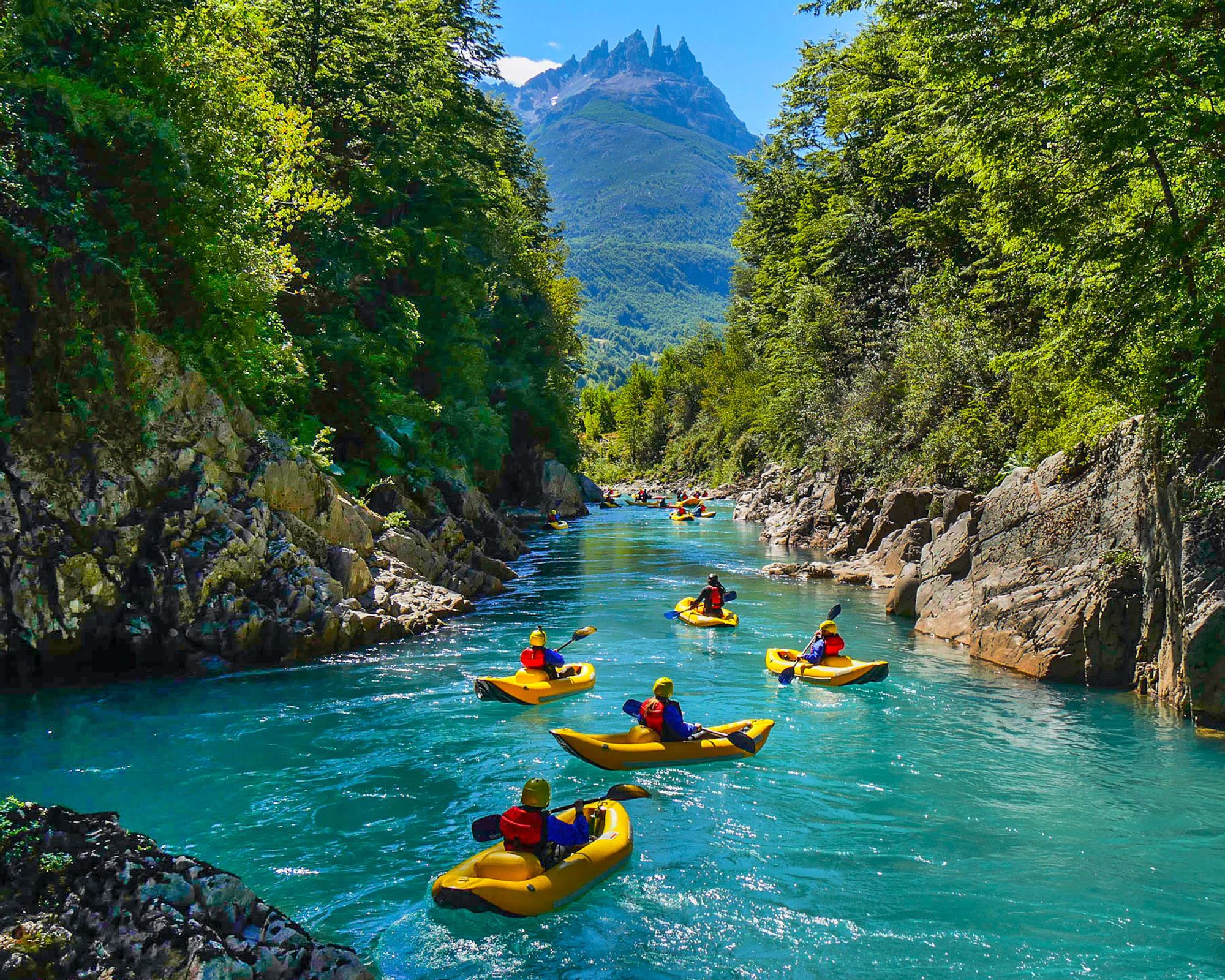 Rafting on a turquoise river in the shadow of the mighty mountains. There are few better sights.