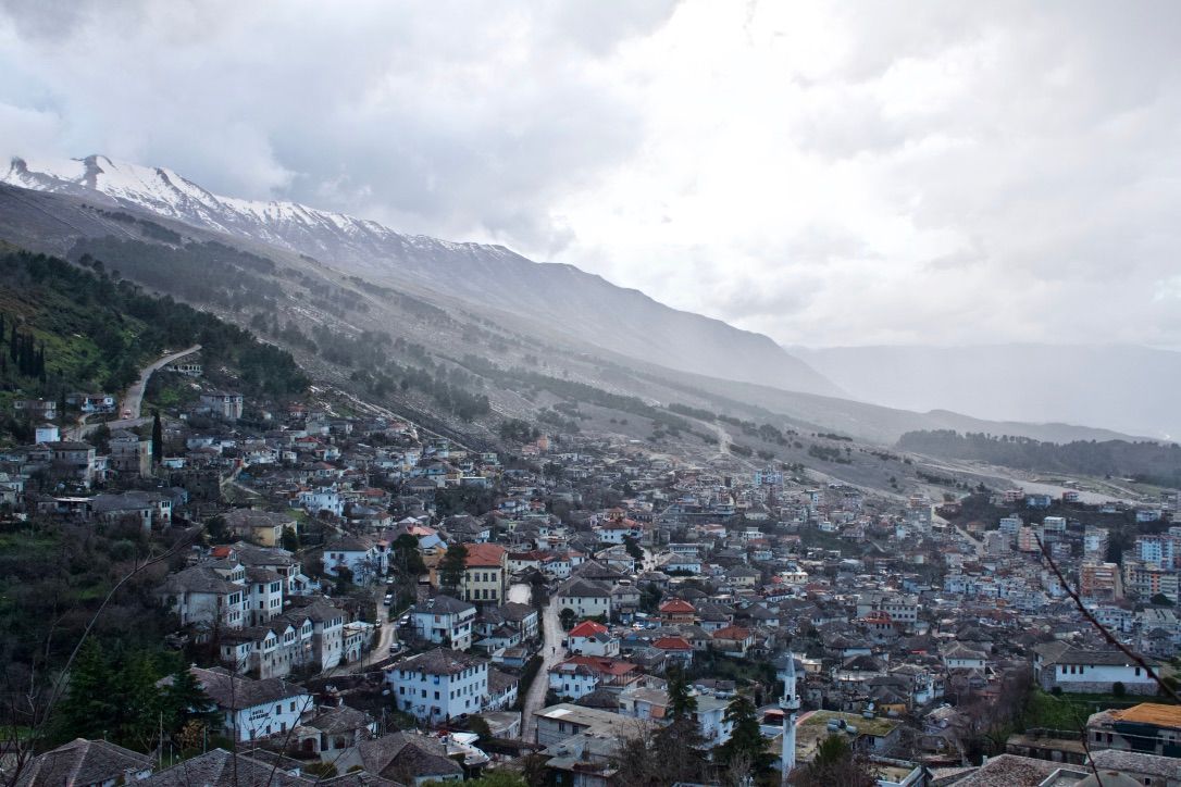 A mountain town on the slopes of a mountain face in Albania.