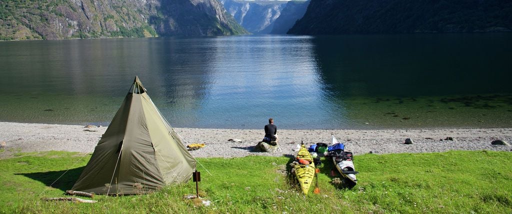 A lone camper at a wild campsite in Naeroyfjord, Norway