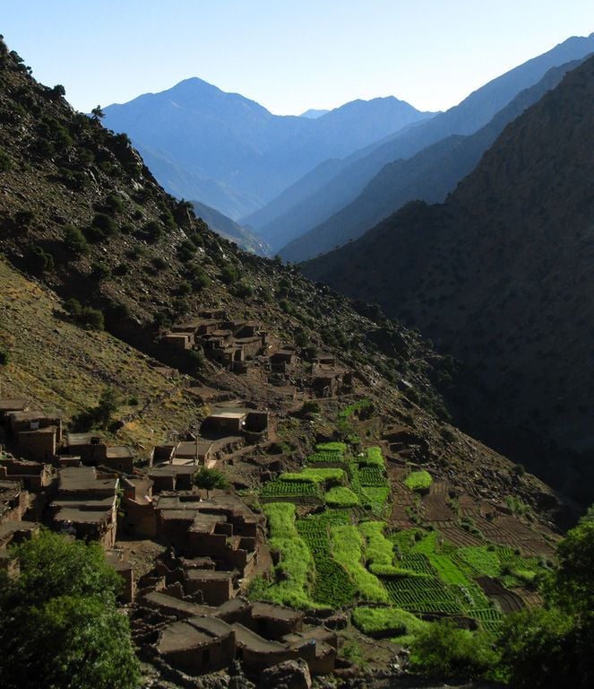 Terraced fields and a traditional village in Morocco's Atlas Mountains.