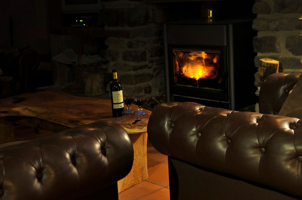 Two glasses of wine by the fireplace in a chalet in France.