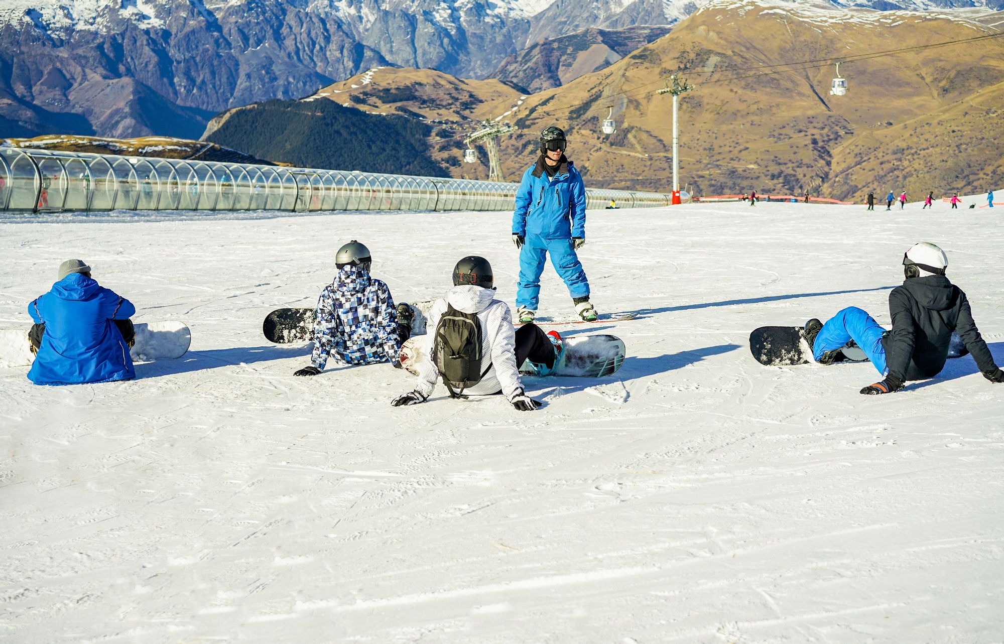 Snowboarding A group learn how to snowboard during a lesson in France.