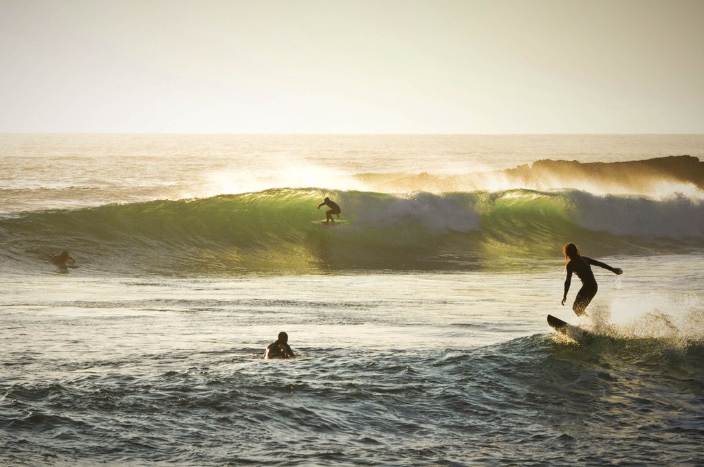 Surfers riding the waves in Taghazout, Morocco