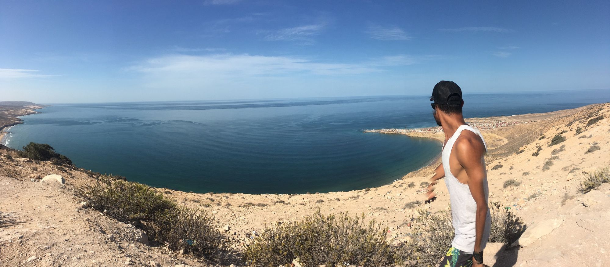 A man looking out over the beach in Taghazout, Morocco