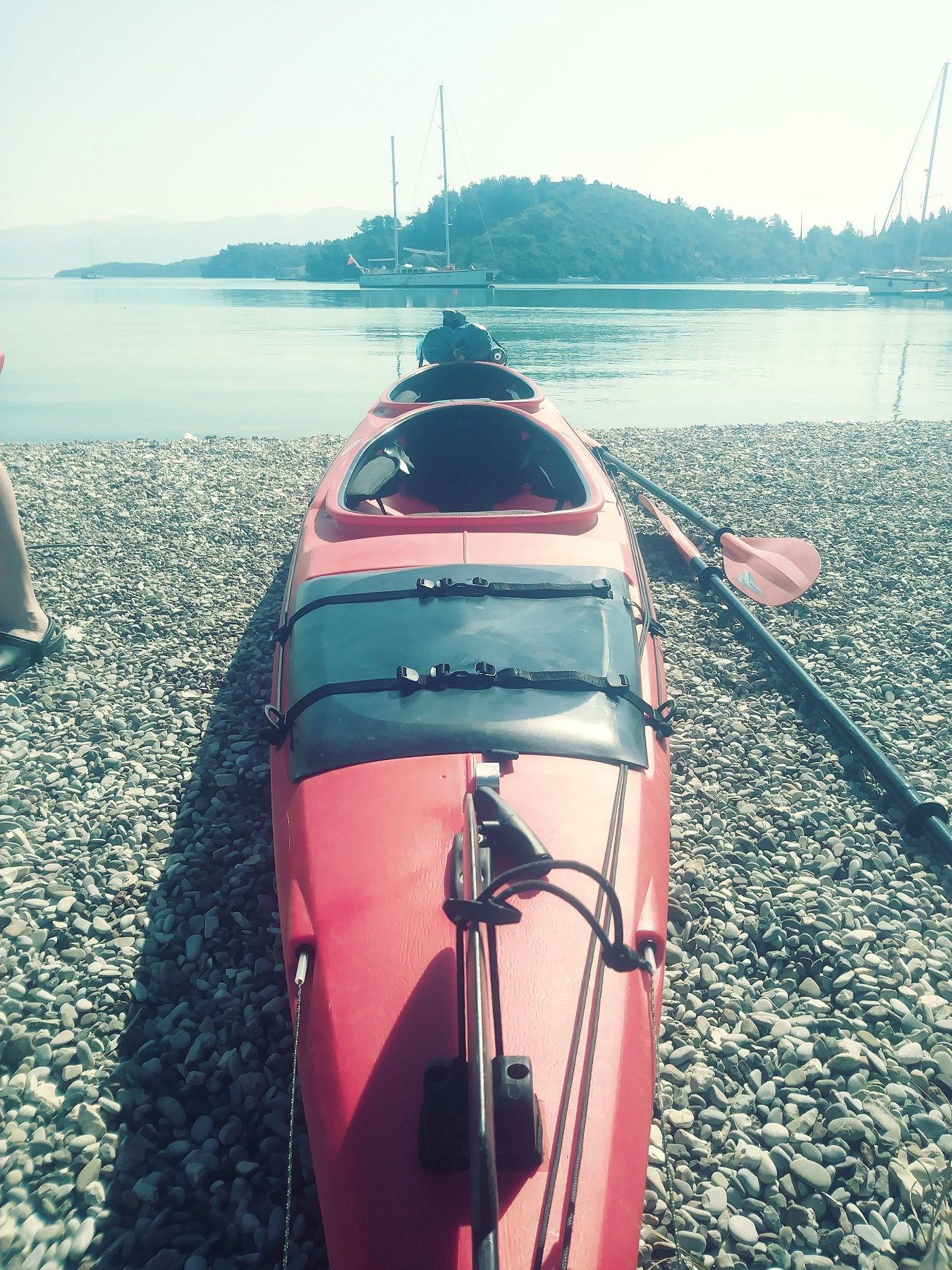 A Kayak on a pebbled beach in Lefkada, Greece.