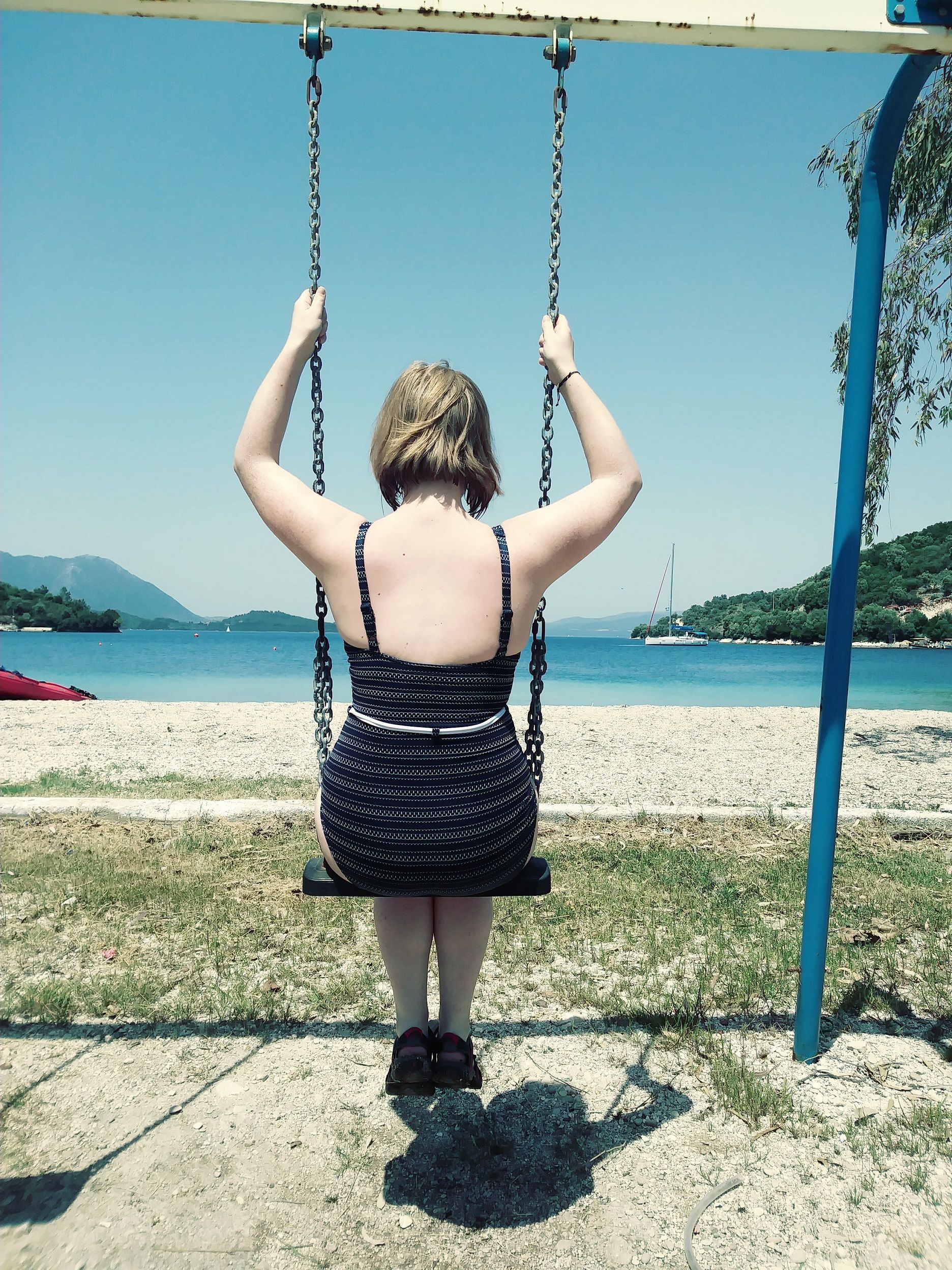 A woman on a swing in Meganisi, Greece