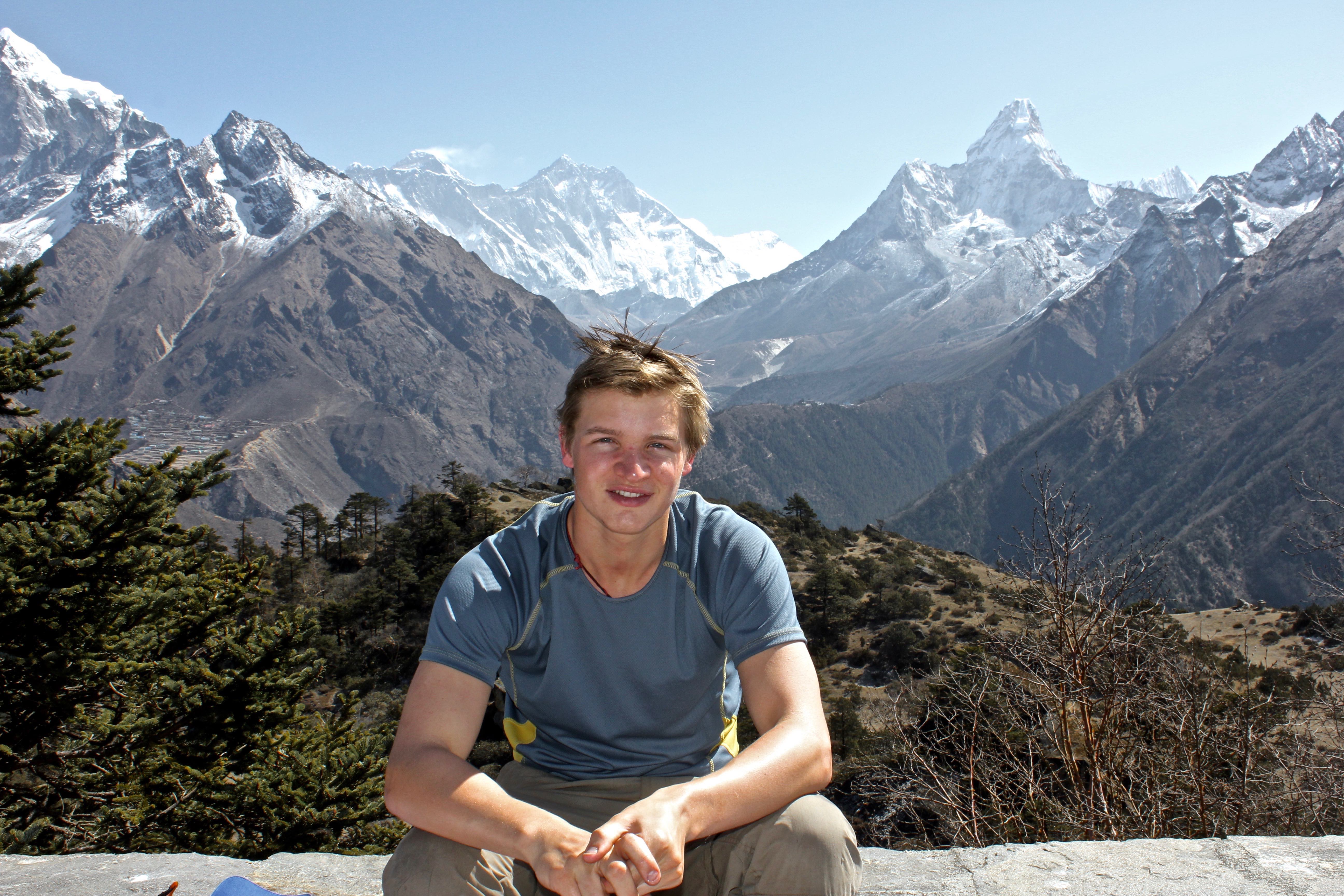 Author Geordie Stewart posing in front of the Himalayas