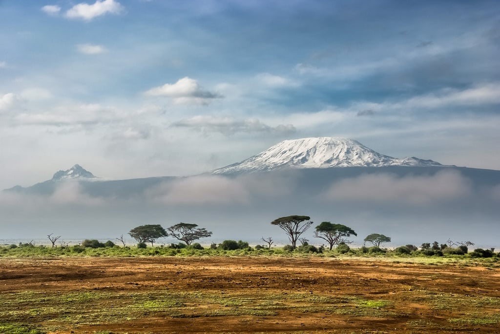 The summit of Mount Kilimanjaro poking through the clouds.
