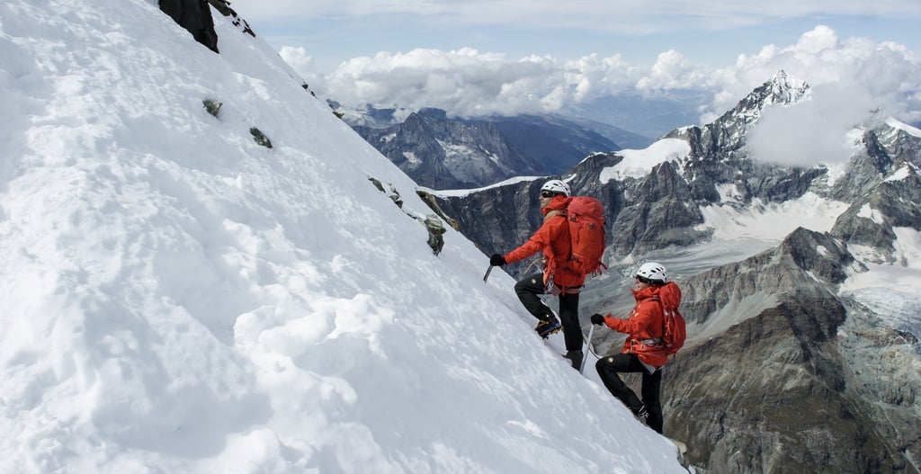 Climbers with ice axes and crampons on Mont Blanc.