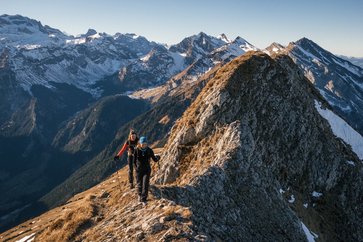 Two hikers crossing a mountain range.