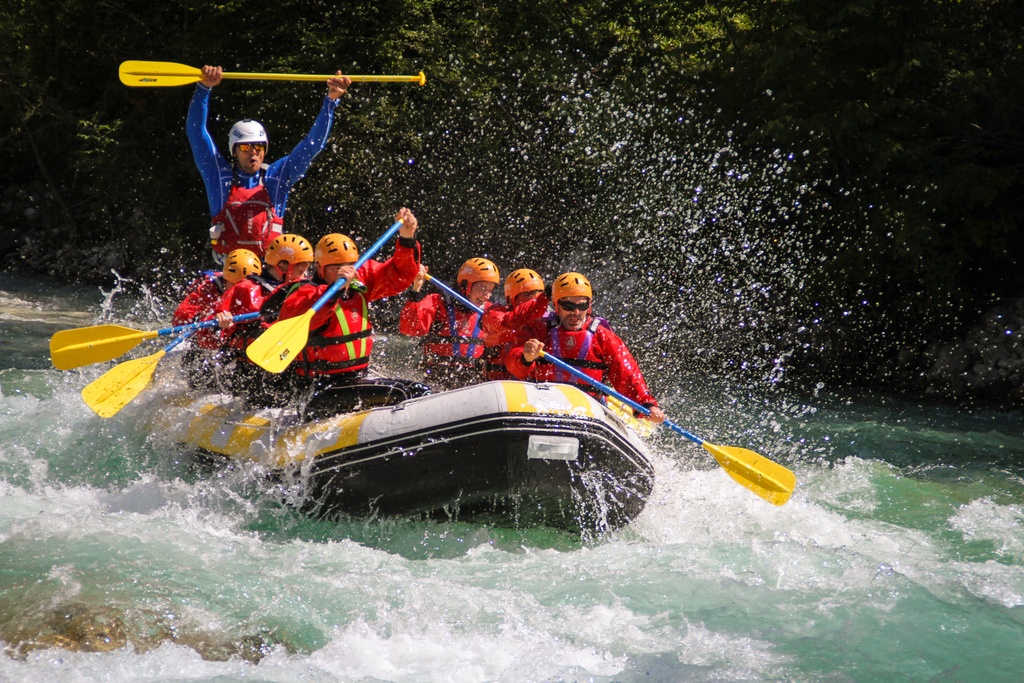 A group white water rafting on the Soca River in Slovenia.