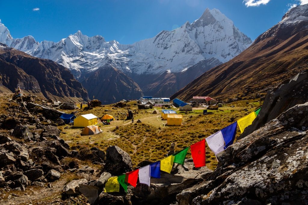 Nepal’s Annapurna Circuit, with prayer flags in the foreground and the Himalayas on the background.