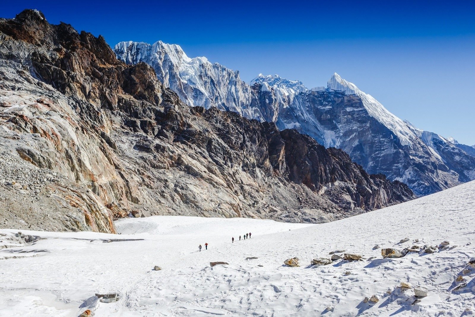 A group of hikers in the Himalayas, tackling the Everest 3 Pass Challenge.