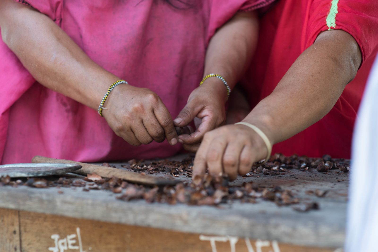 Women in Peru drying cacao beans to make Asháninka chocolate.
