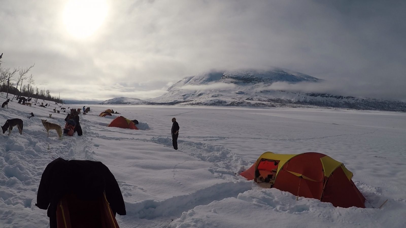 Tents surrounded by several inches of snow in the Arctic Circle.