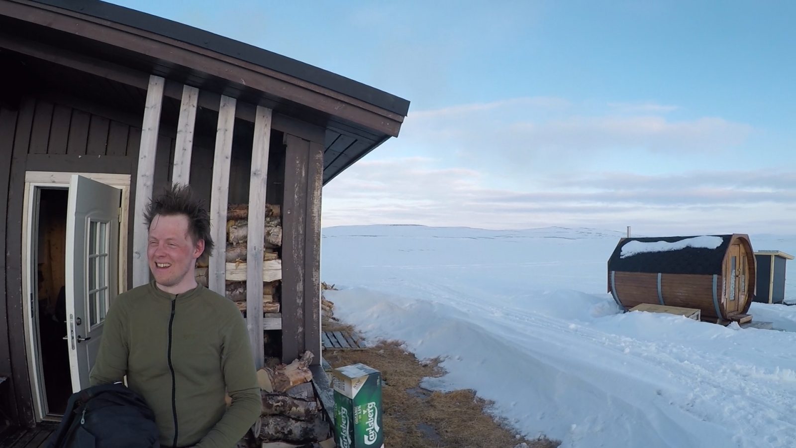 A man emerges from a sauna in the Arctic.