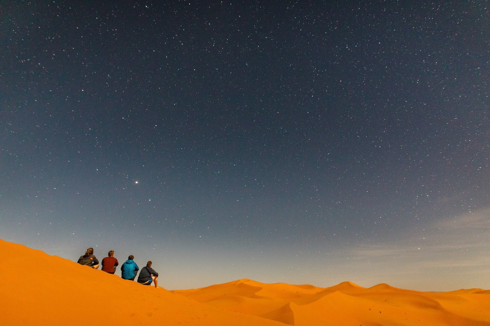 Sitting on sand dunes in Morocco