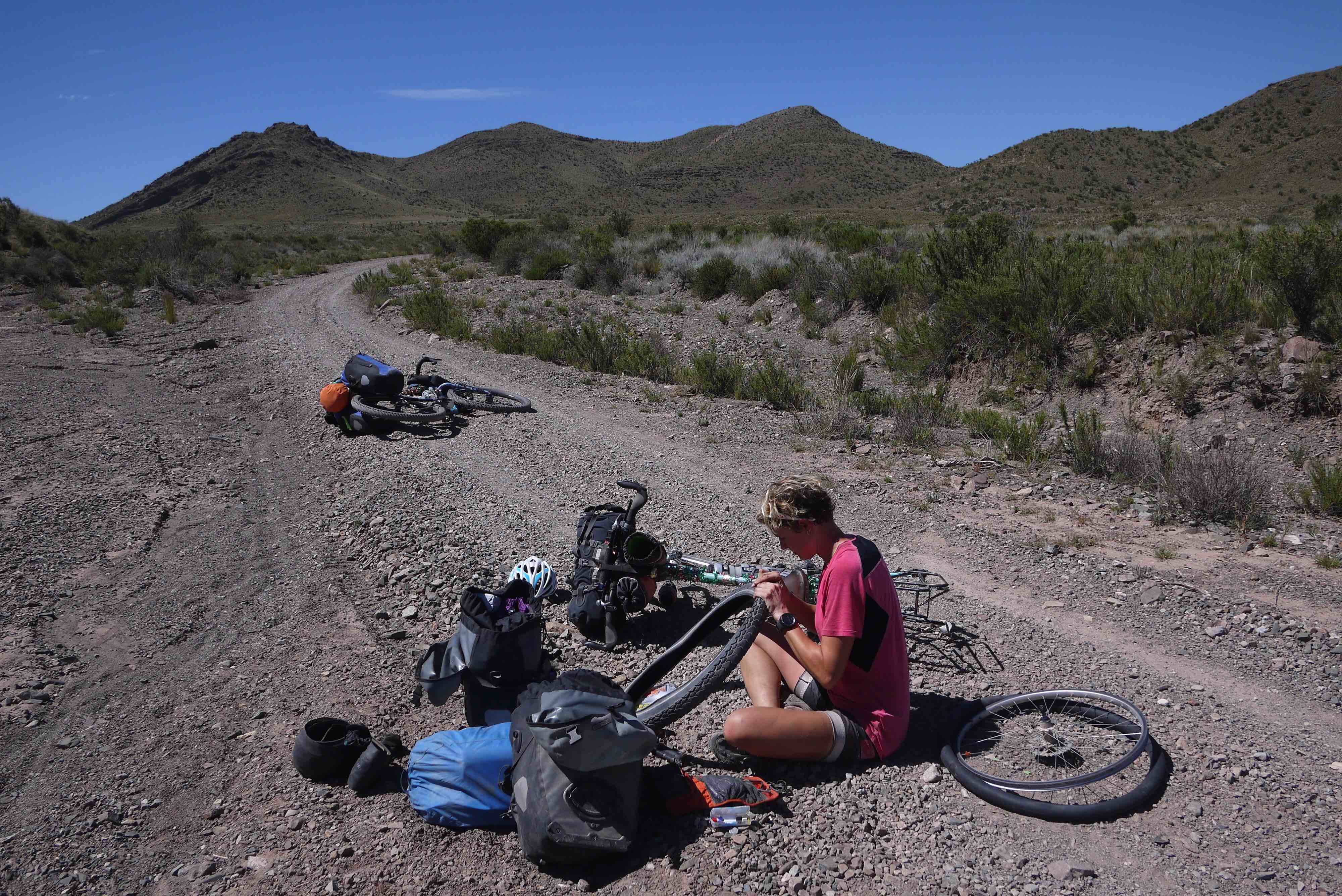 Cyclist Anna Nuff mending a puncture on the road 