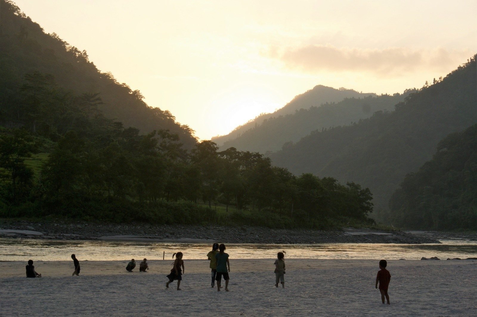 Children play on the beaches along the river, often cheering on the rafters.