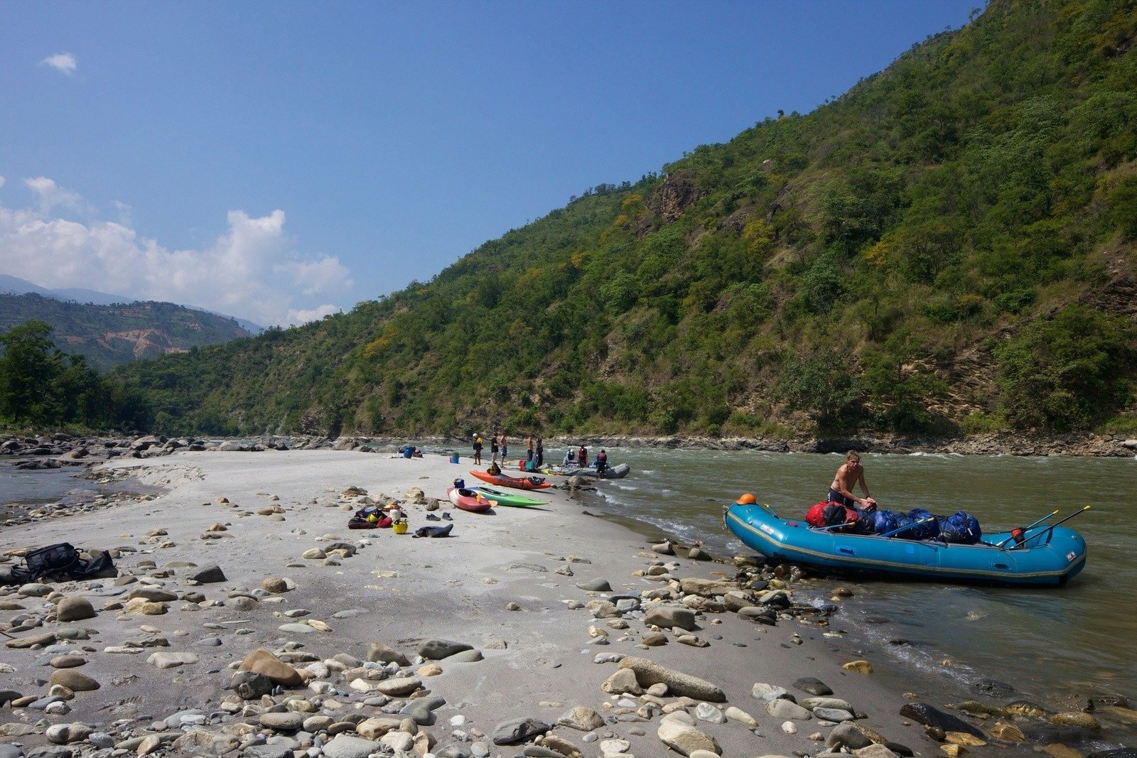 Rafters come ashore after a spell on the water of the Sun Kosi river.