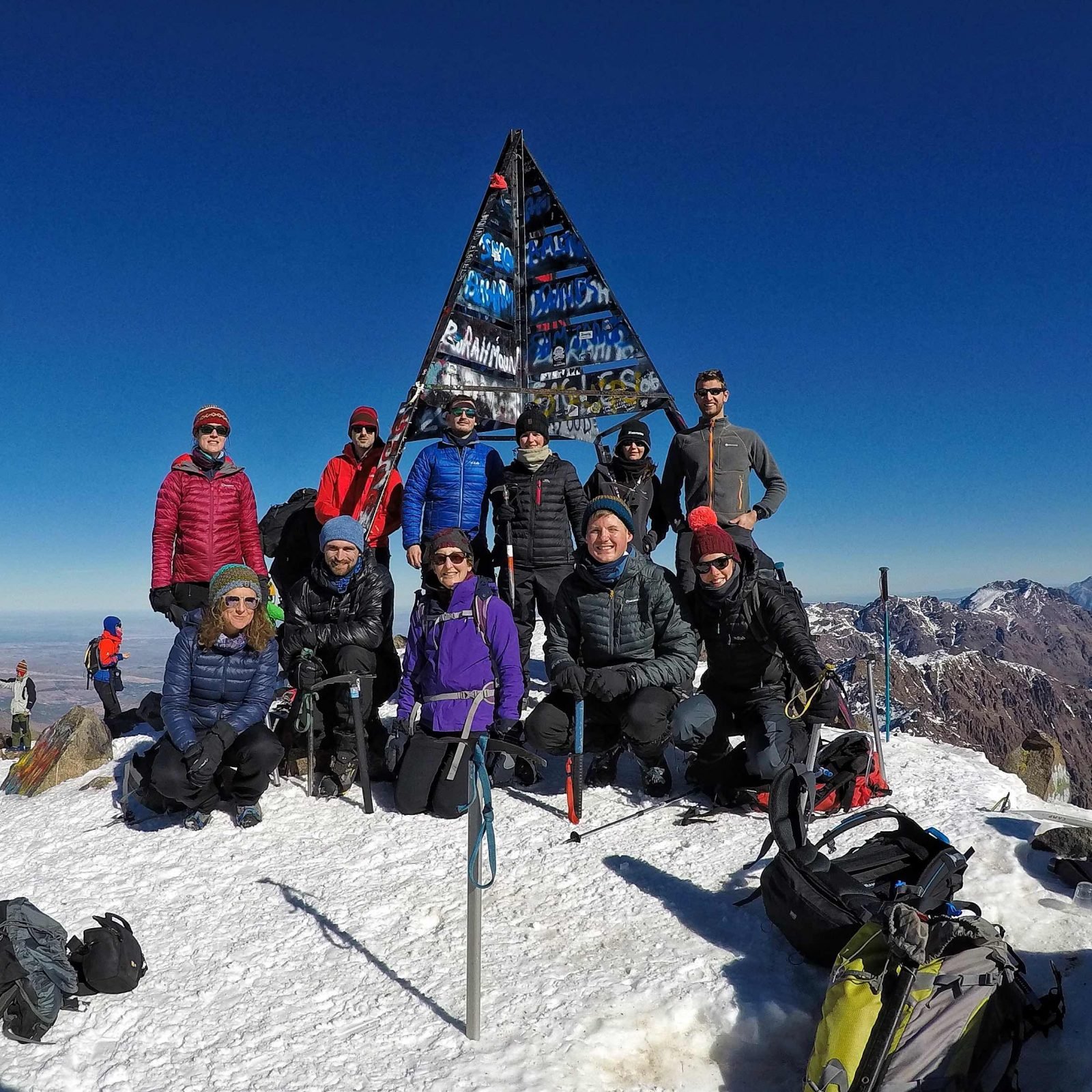 A group hiking photograph on the summit of Mount Toubkal.