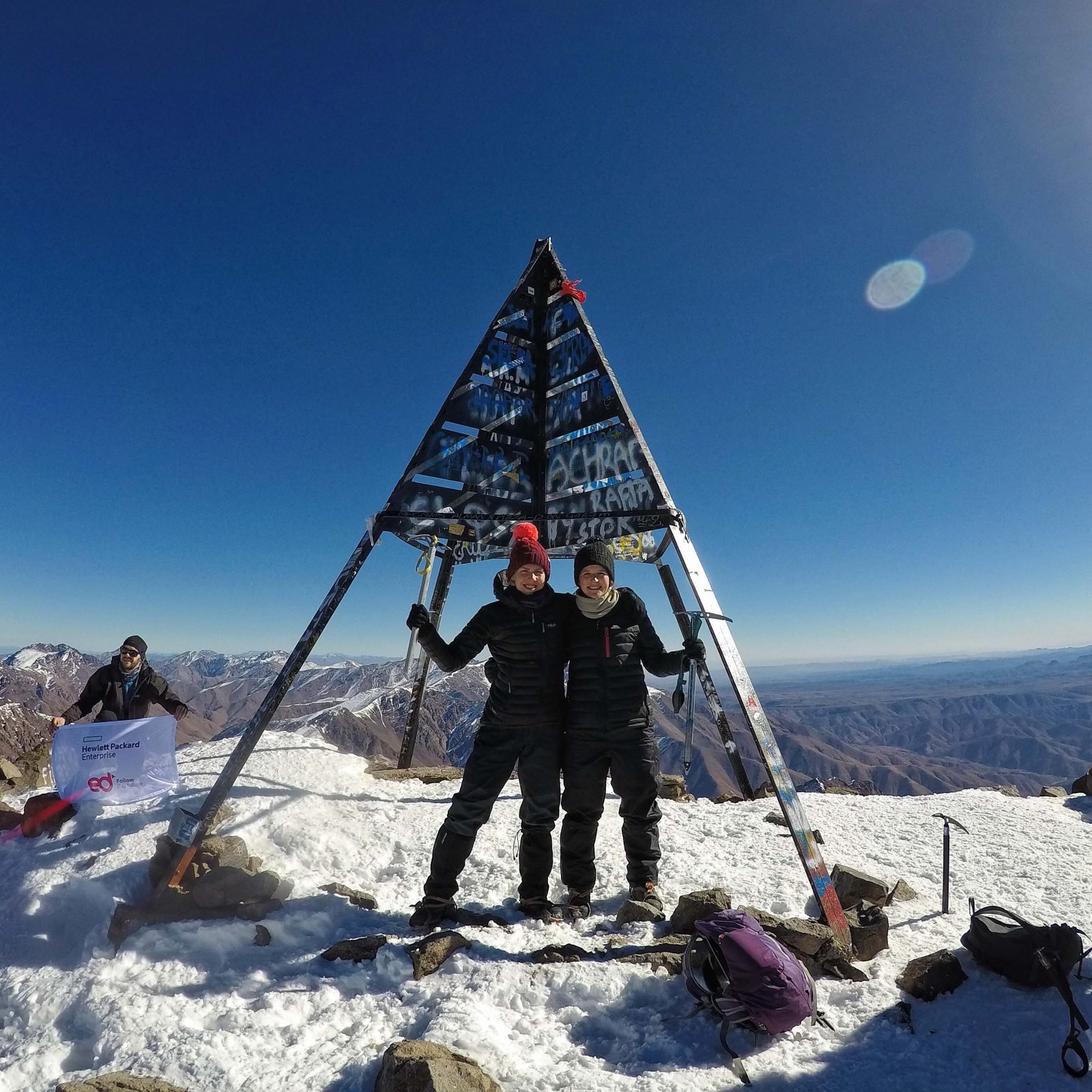 Two hikers posing at Mount Toubkal summit.
