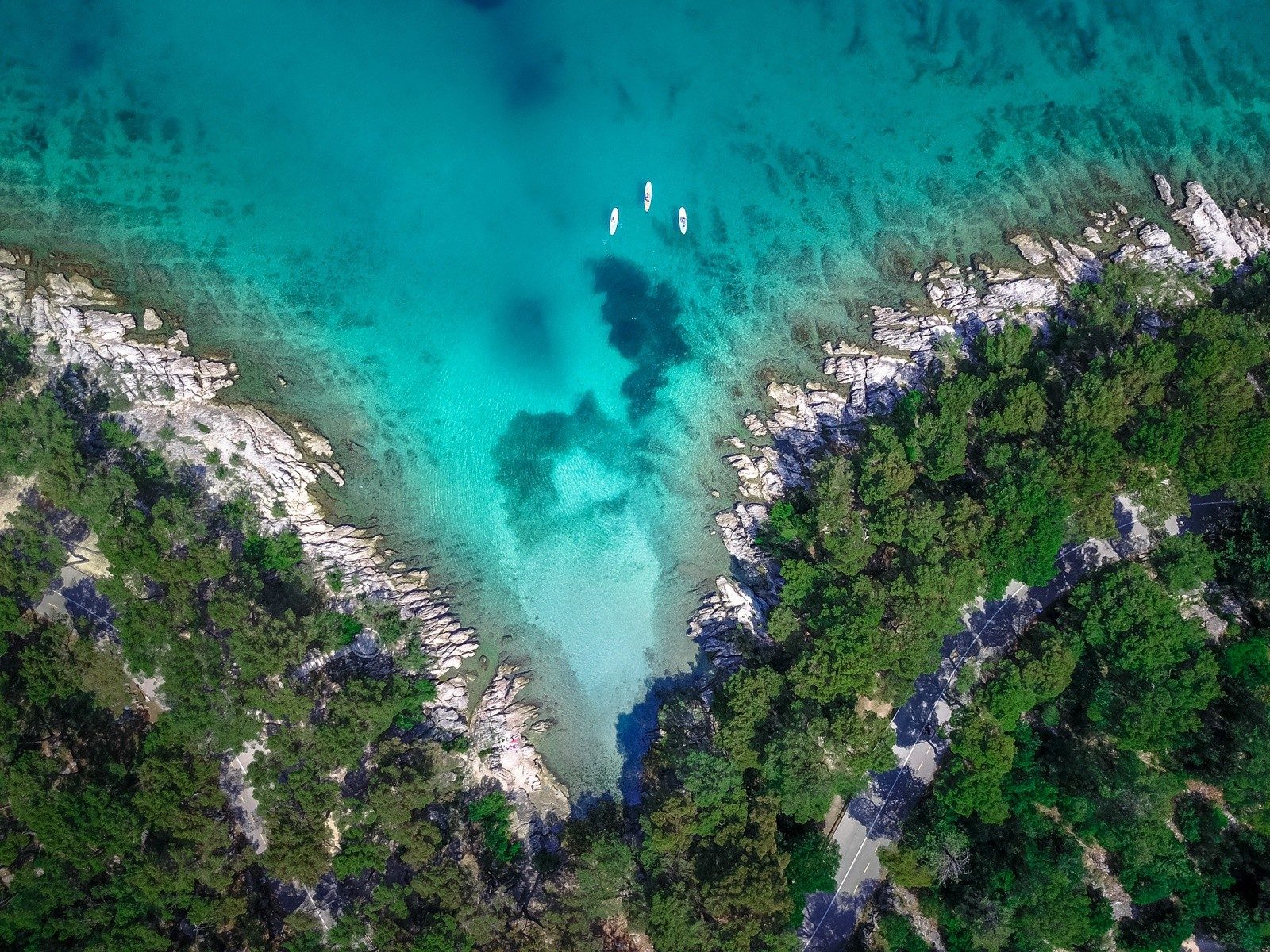 An aerial view of SUPers on the water in the Split Peninsula, Croatia.