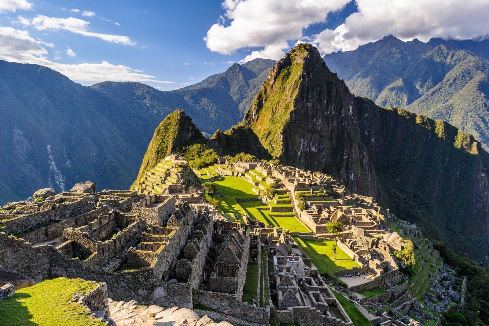 A view of Machu Picchu in Peru, surrounded by mountains.