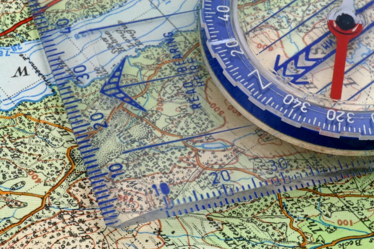 A close up of a map and compass