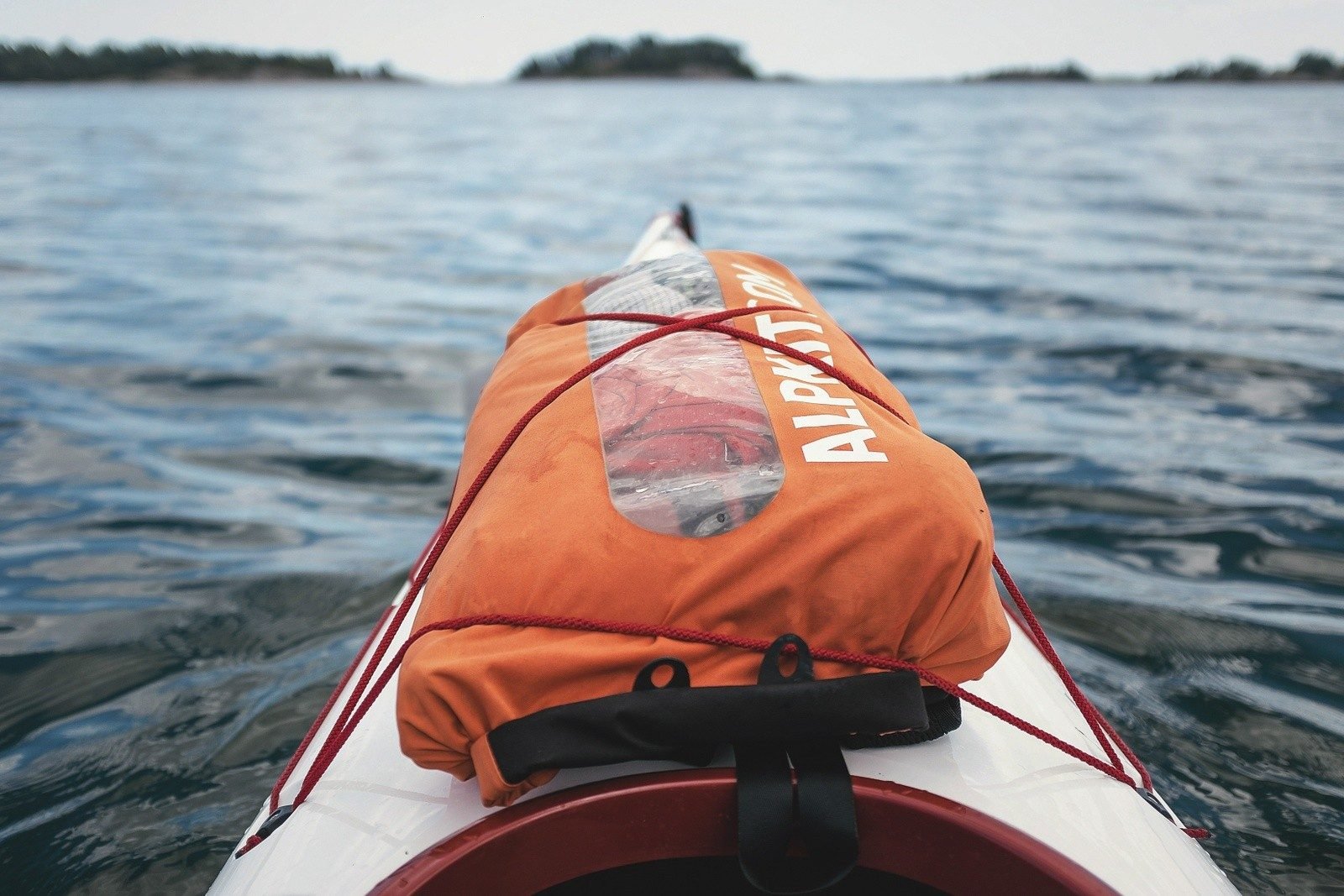 A dry bag on the front of a kayak.