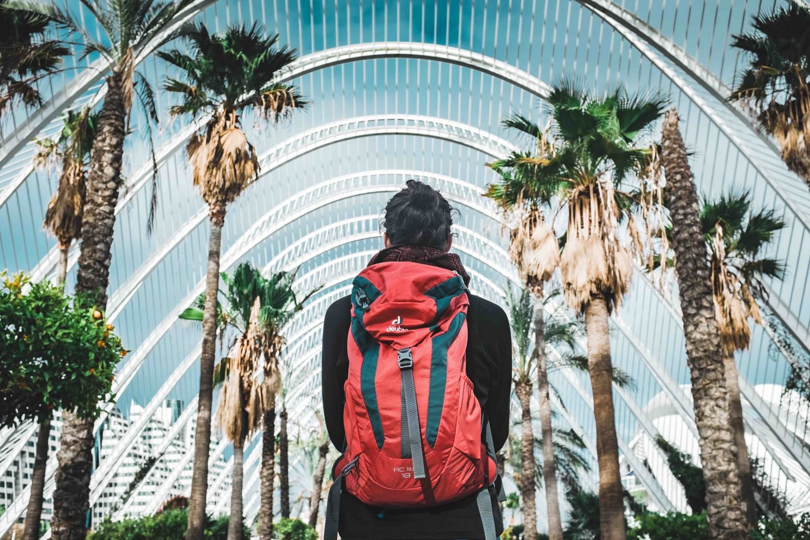 A hiker standing inside a garden hothouse