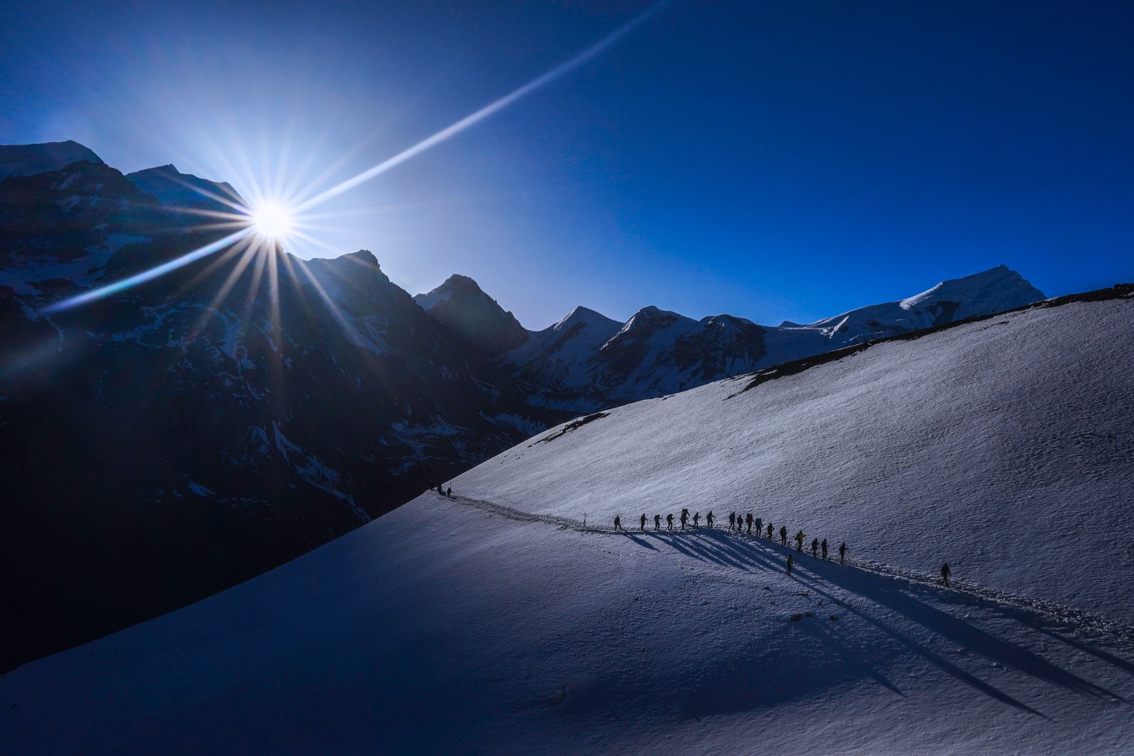 Trekkers crossing the Thorong La Pass, Nepal, in the snow