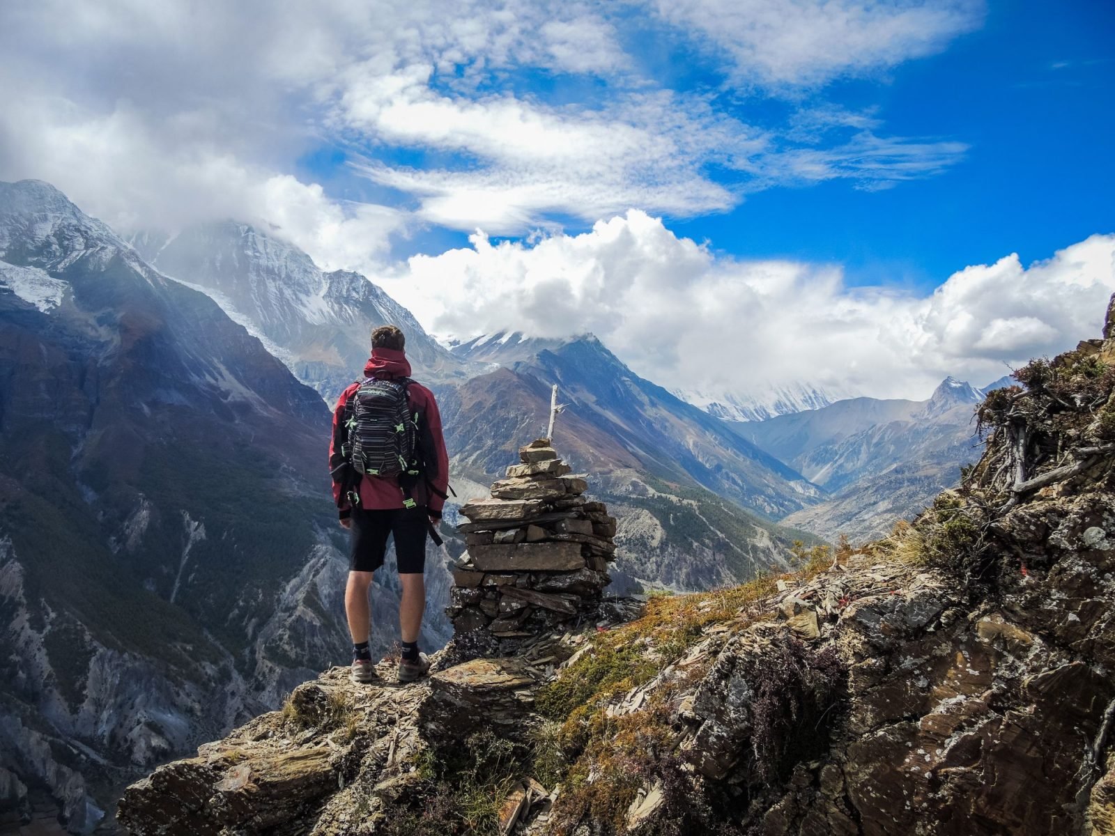 A hiker looks out over the picturesque Manang Valley in Nepal