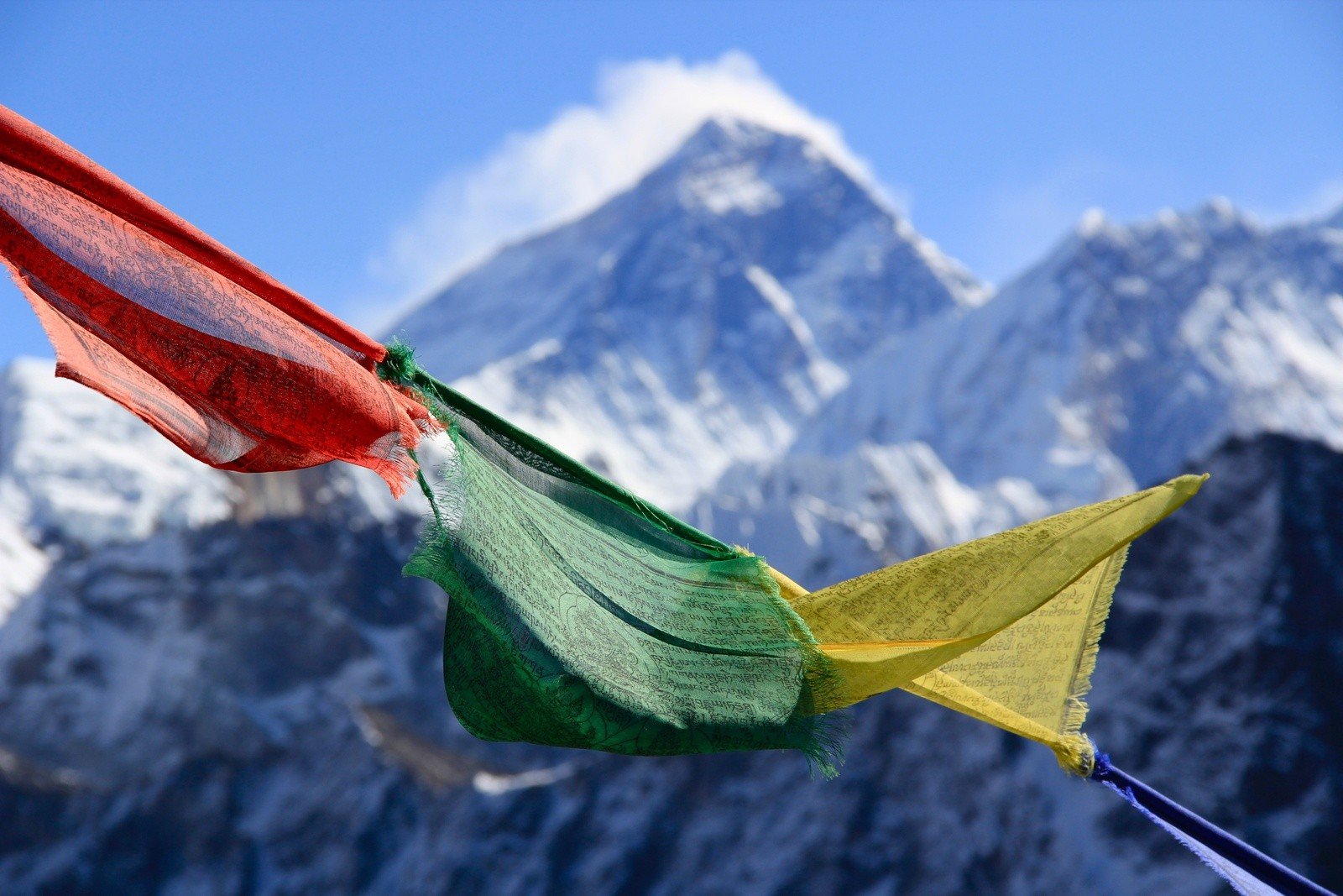 Prayer flags in front of the summit of Mount Everest.