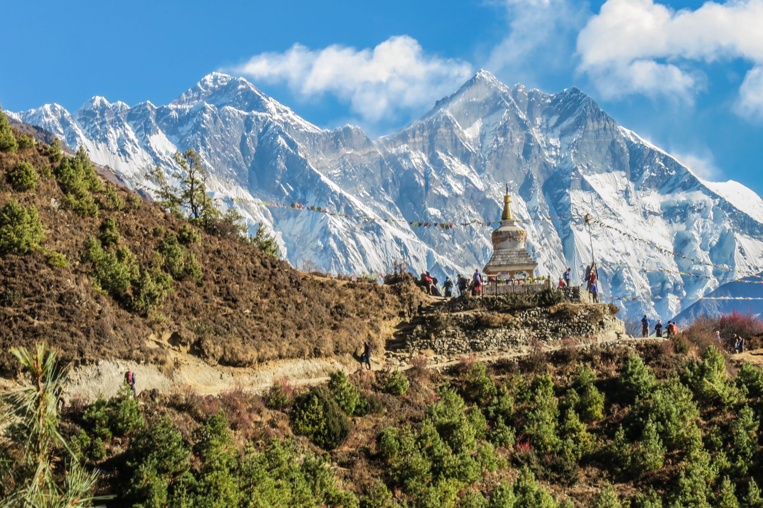 A stupa in Nepal with the snowcapped Himalaya mountains behind.