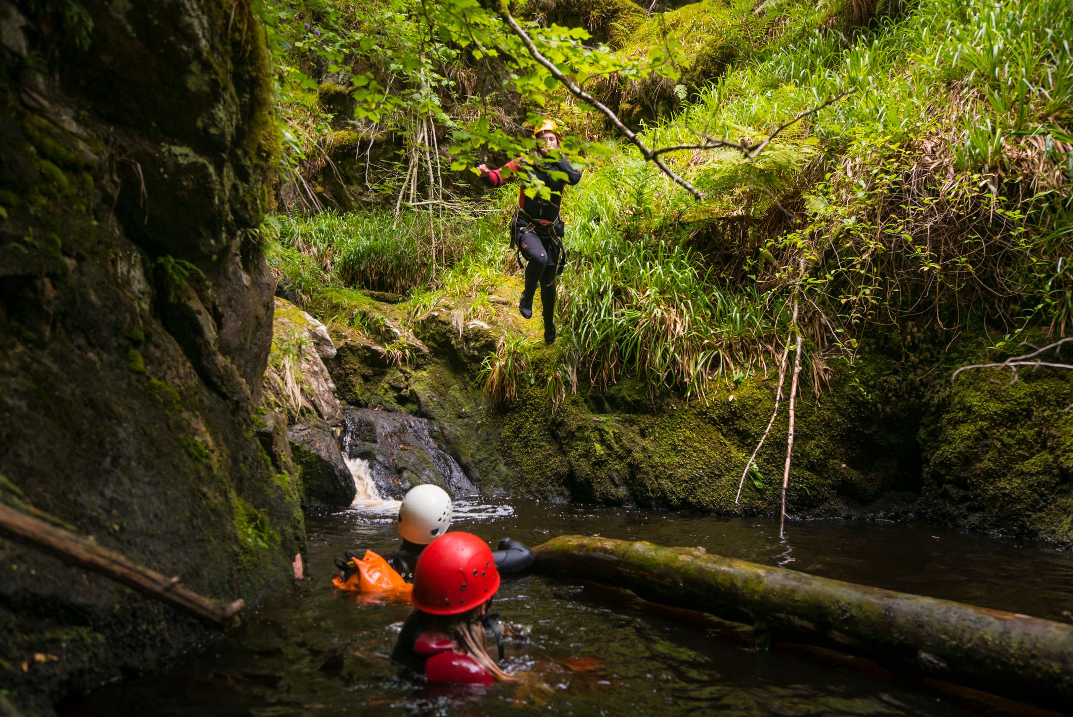 Three people out canyoning.
