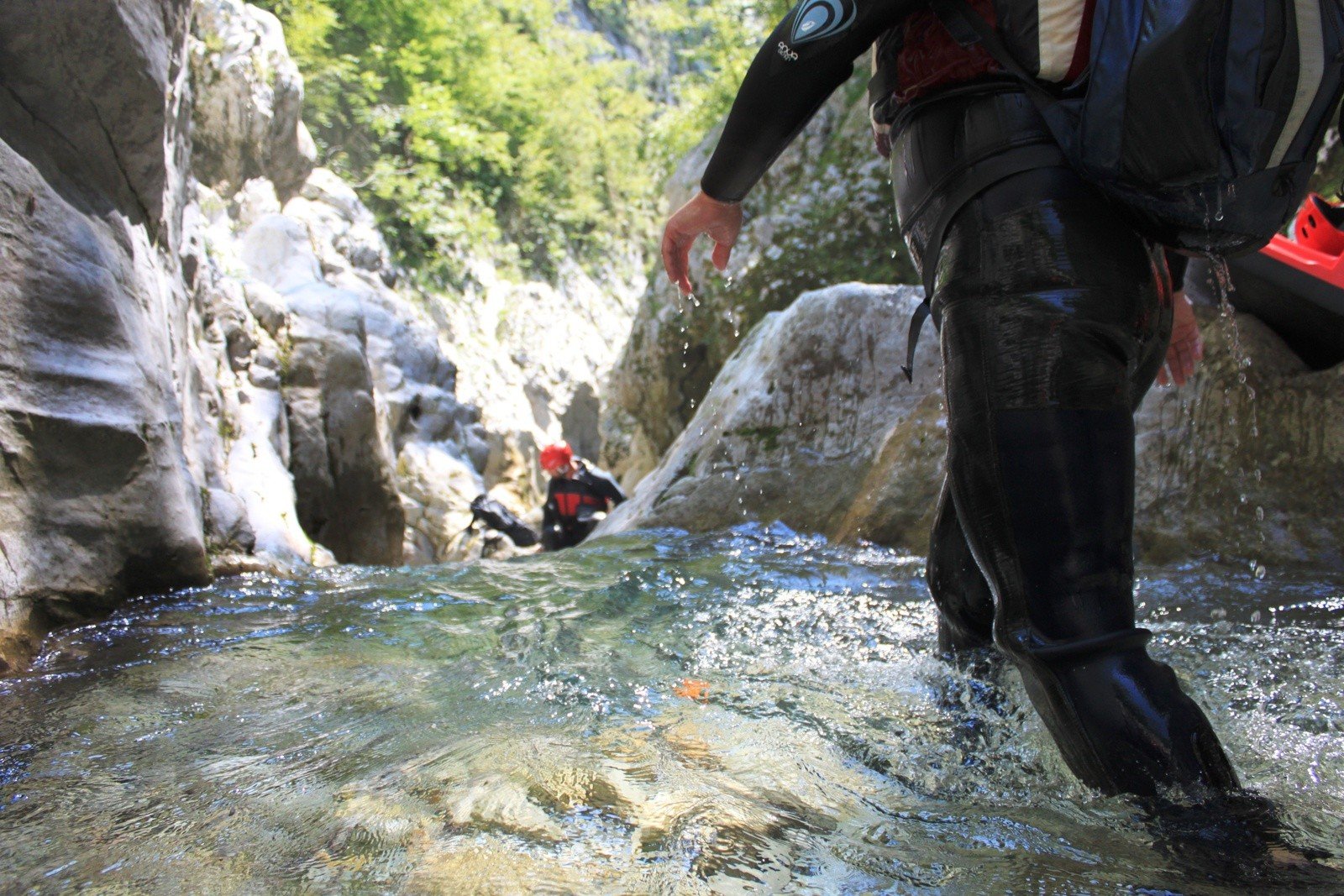 Two people walking down a river canyon in Croatia