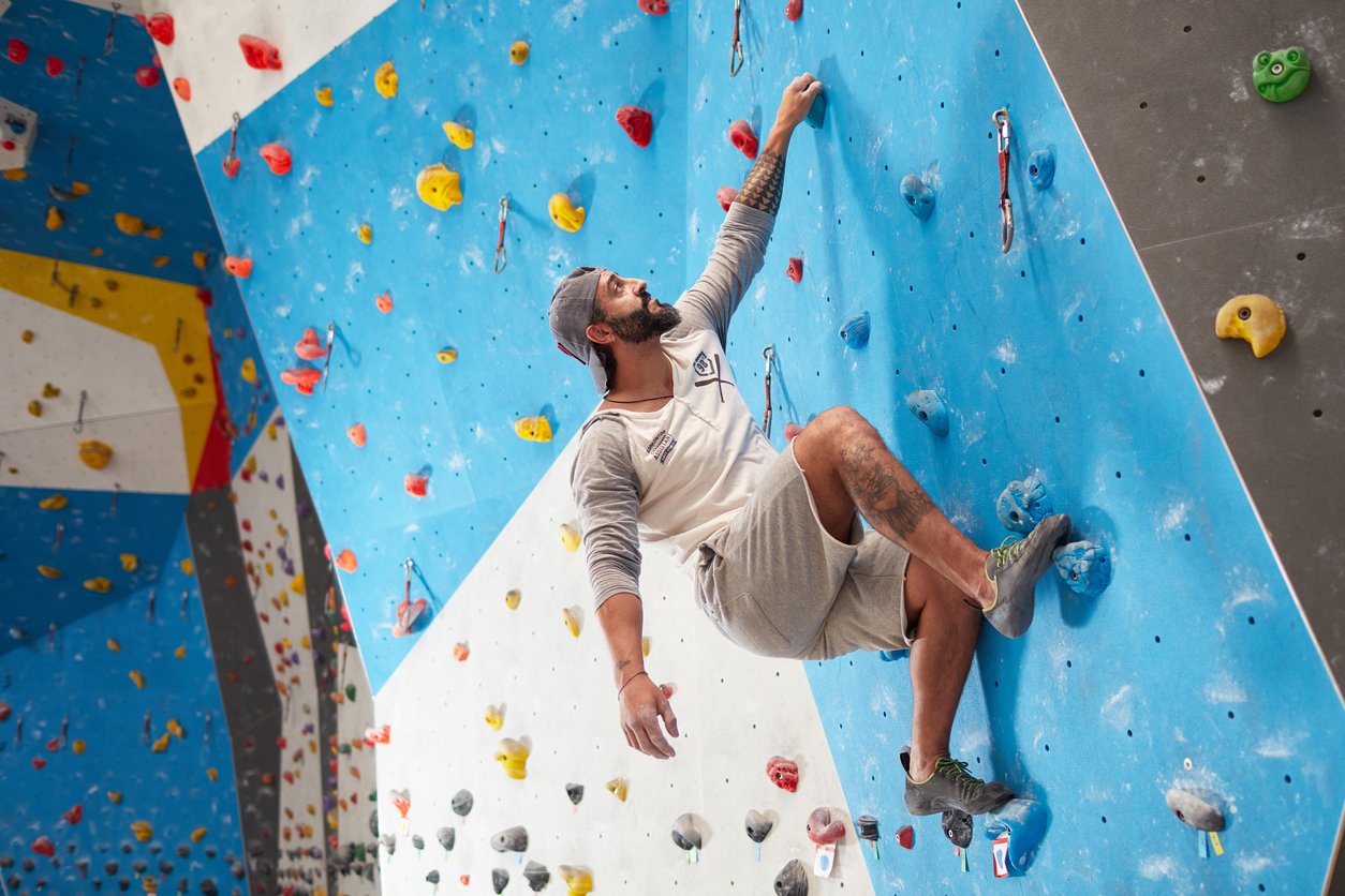 A man bouldering indoors