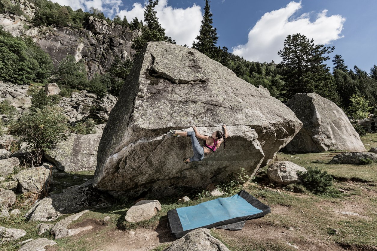 A woman bouldering in the Pyrenees.