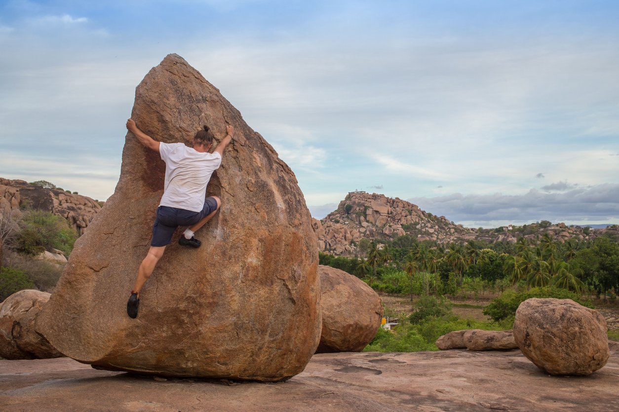 A climber on a boulder in Hampi, India.