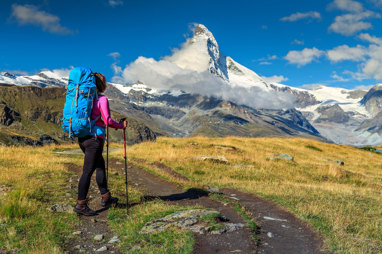 Sporty hiker woman with Matterhorn peak in background, Valais, Switzerland 