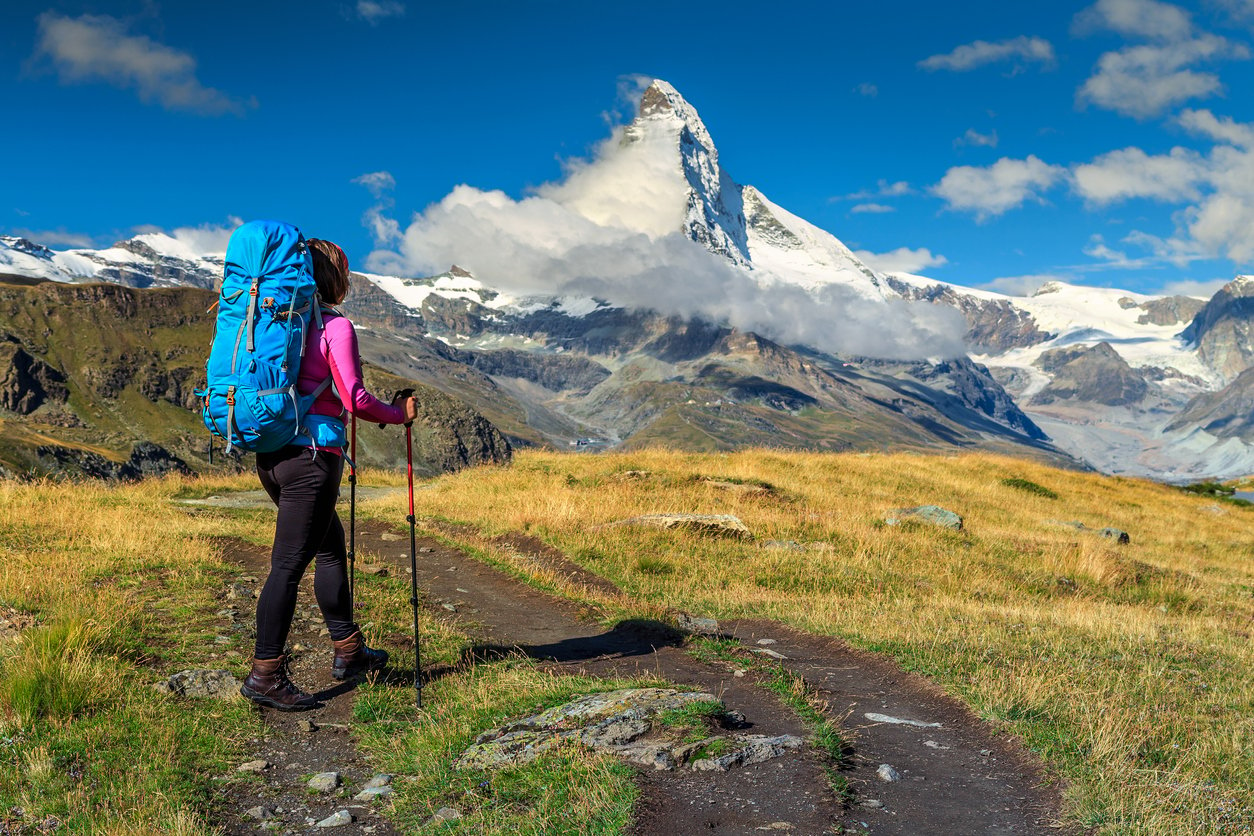 A hiker trekking the Matterhorn Circuit, Valais, Switzerland Swiss Alps