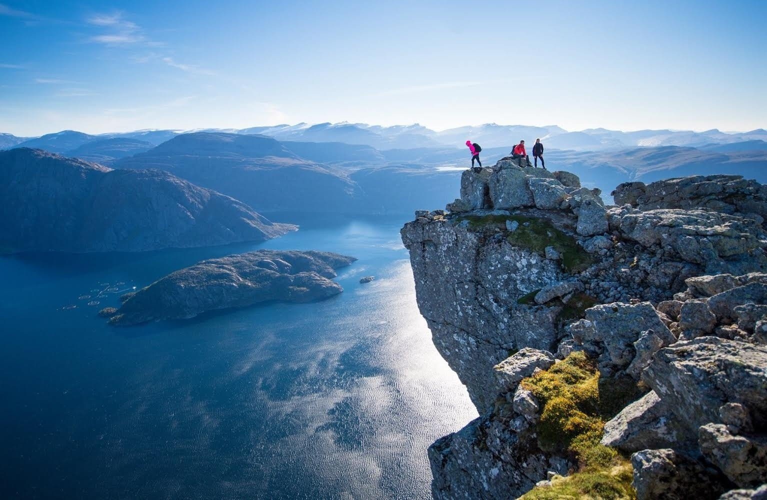 Hikers at the top of the Norwegian fjords.