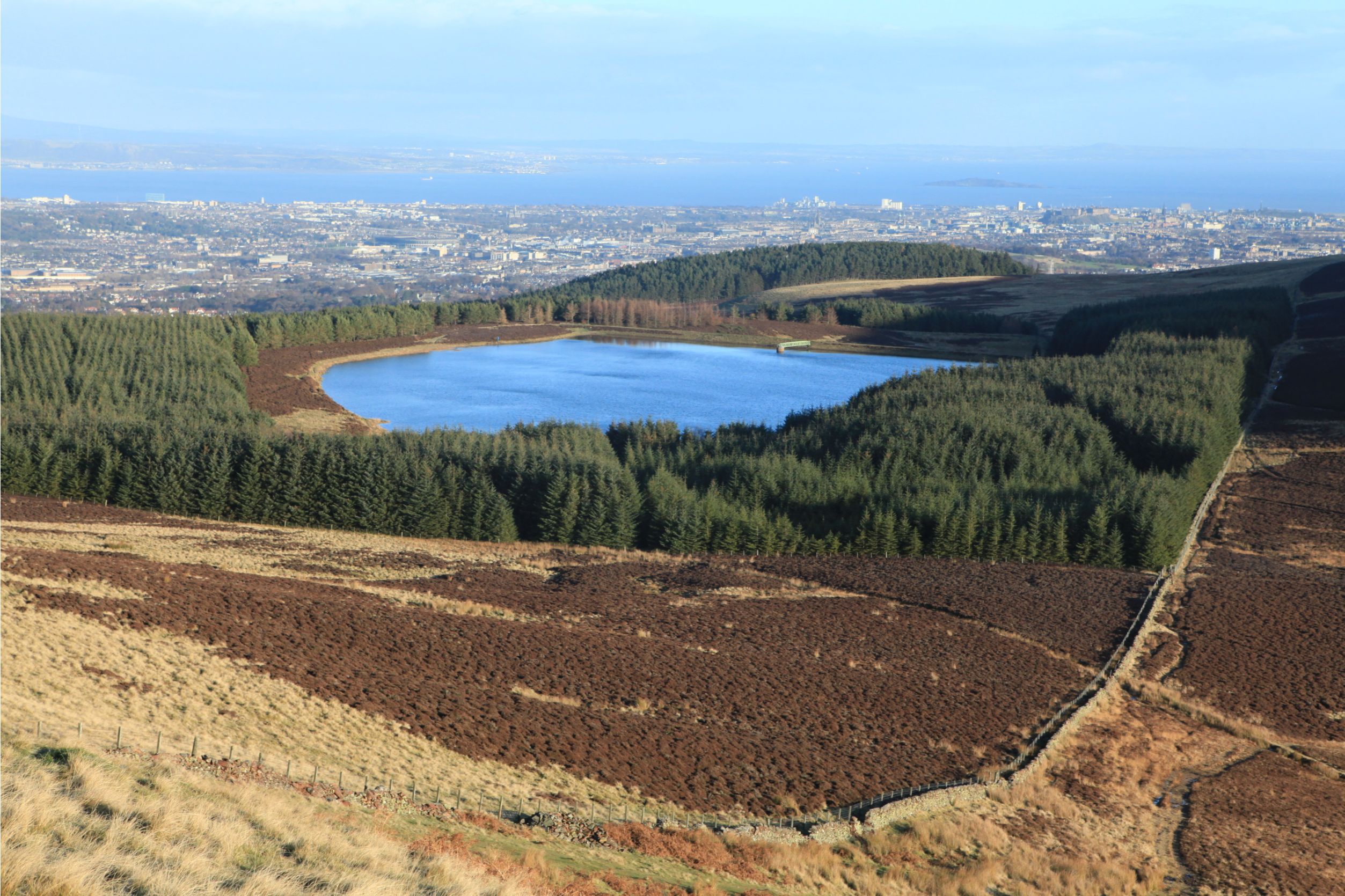 Bonaly Reservoir from the top of Harbour Hill, looking back over Edinburgh from the Pentland Hills.