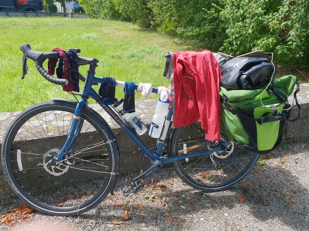 Wet washing hanging from a bicycle...