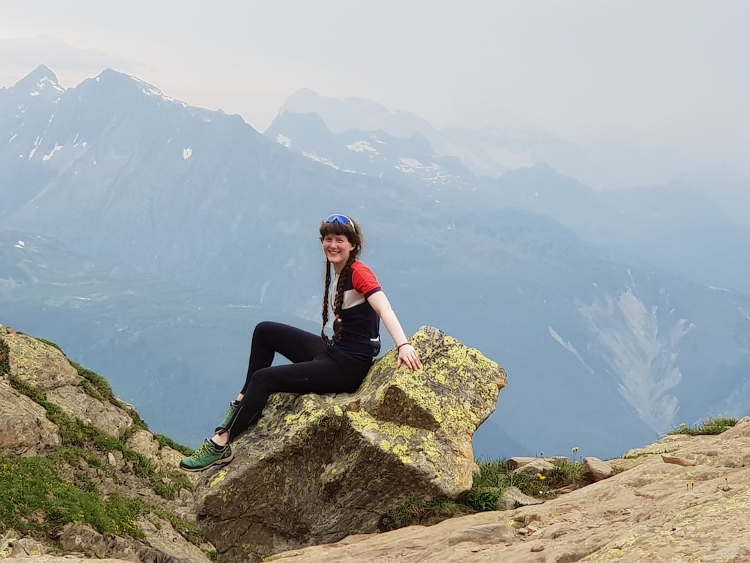 Woman poses on a rock near Andermatt, by glacial Lake Toma, which is the source of the Rhine.