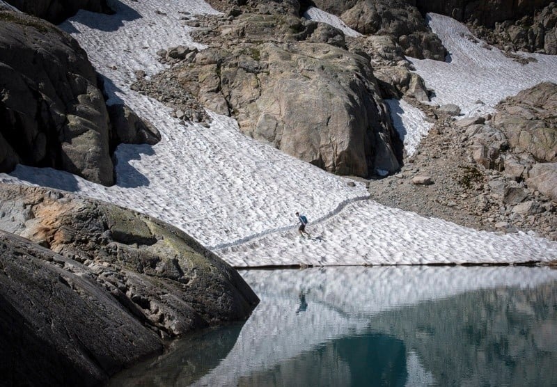 A walker on the Haute Route, Alps, in the snow.