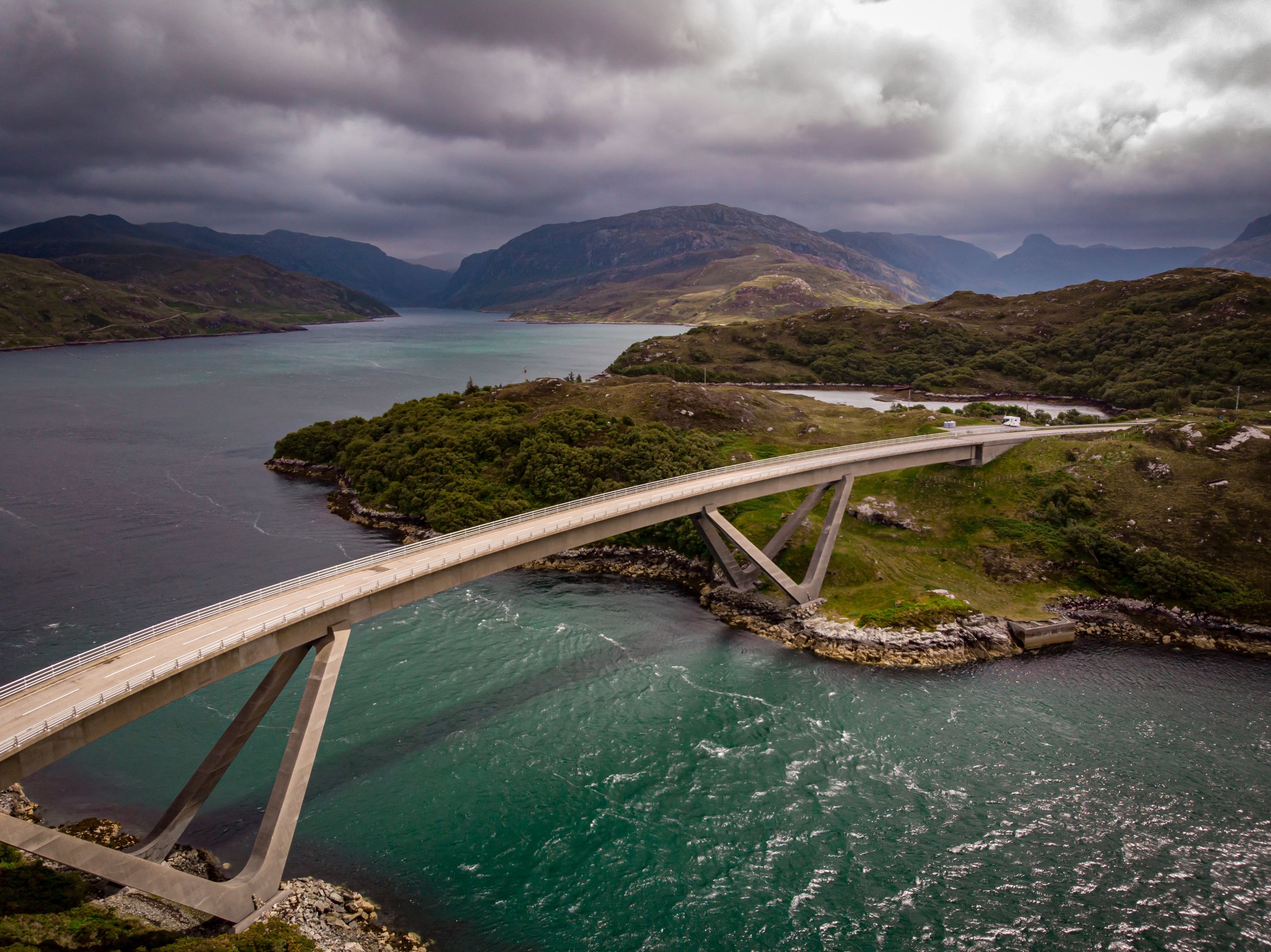 The remarkable Kylesku Bridge between Loch a’ Chairn Bhain and Loch Gleann Dubh, on the North Coast 500 cycling route.